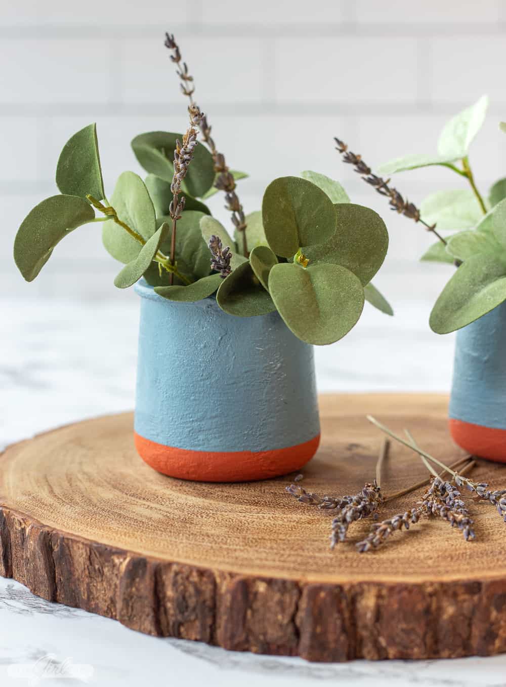 DIY painted replica La Fermiere yogurt pots with greenery on a wooden charger