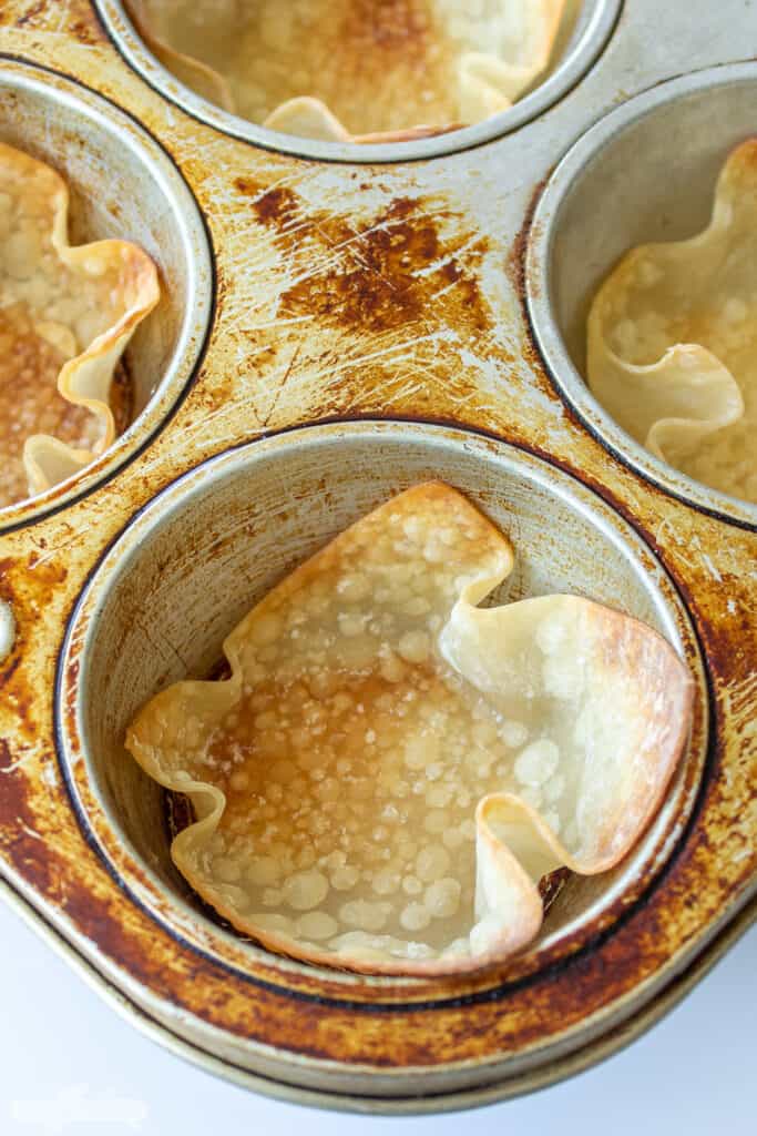 baked crispy wonton cup in a muffin pan