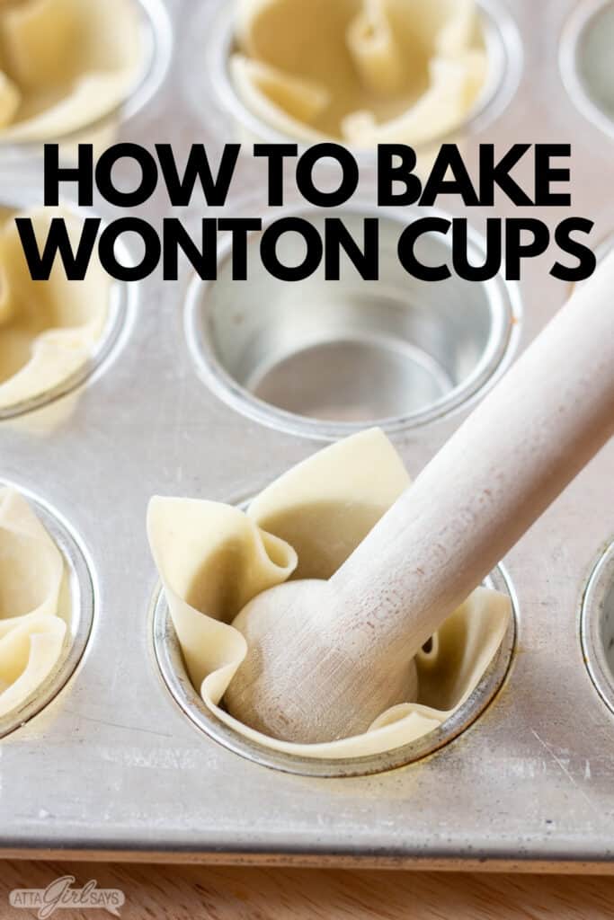 using a wooden tamper to press wonton wrappers into a muffin tin