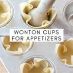 using a wooden tamper to press wonton wrappers into a mini muffin tin