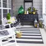 summer front porch decorated with black and white furniture and lemon yellow and green accents