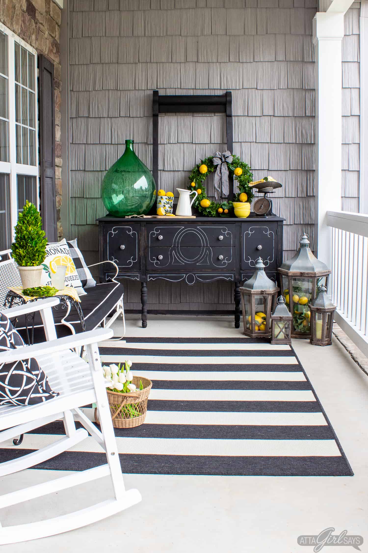 summer front porch decorated with black and white furniture and lemon yellow and green accents