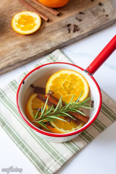 cinnamon orange and rosemary stovetop potpourri in an enamel pot