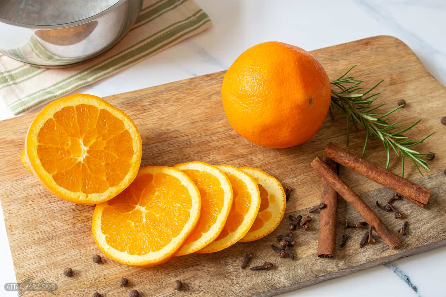 sliced oranges, cinnamon sticks, spices and herbs for stovetop potpourri