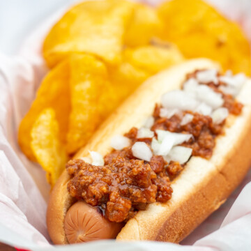 hot dog with chili, onions and potato chips