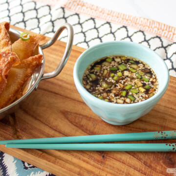 bowl of dipping sauce with fried wonton