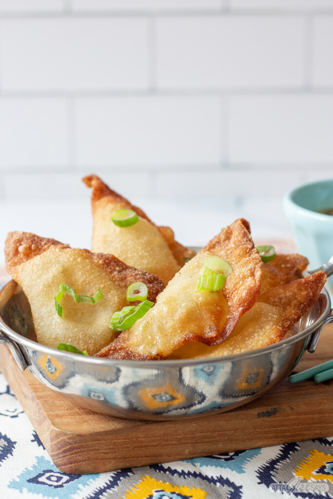 cream cheese wontons in a silver serving bowl