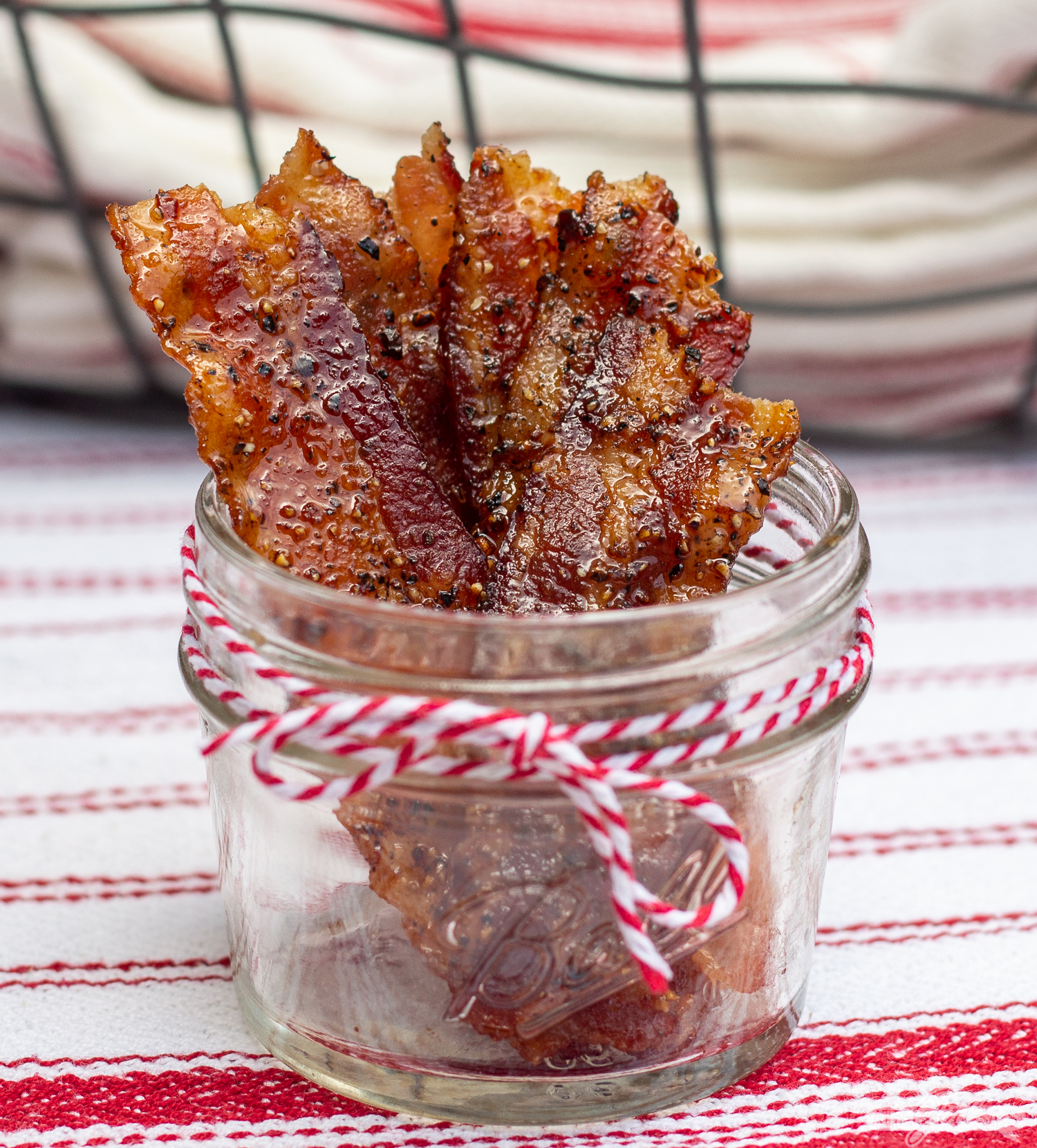candied bacon slices in a mason jar