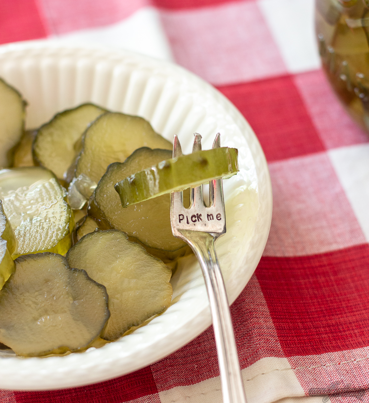 pickle on a silver fork embossed with pick me