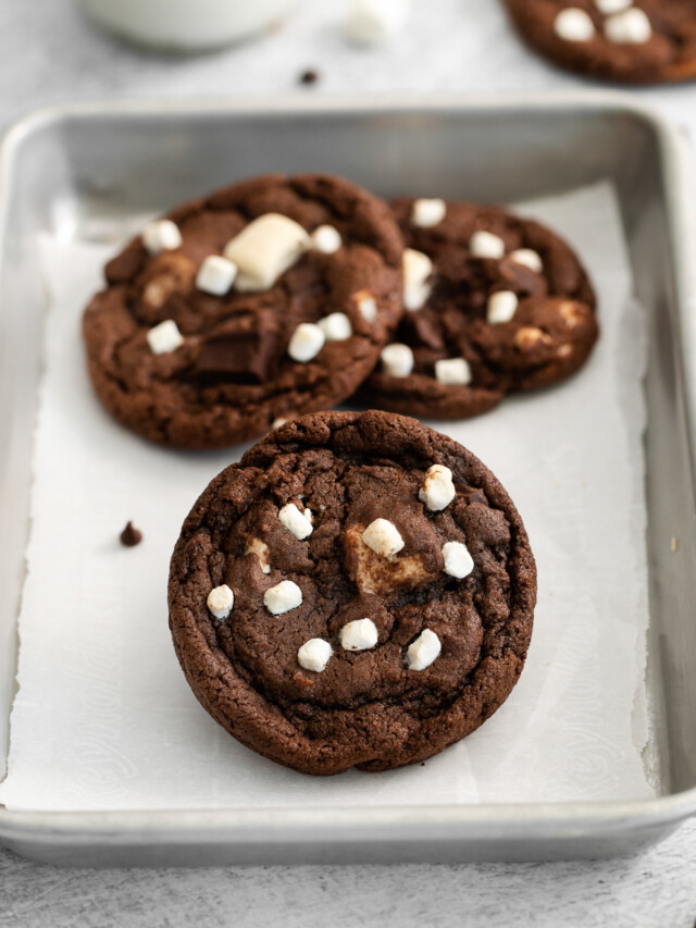 chocolate hot cocoa cookies with marshmallows on a baking pan