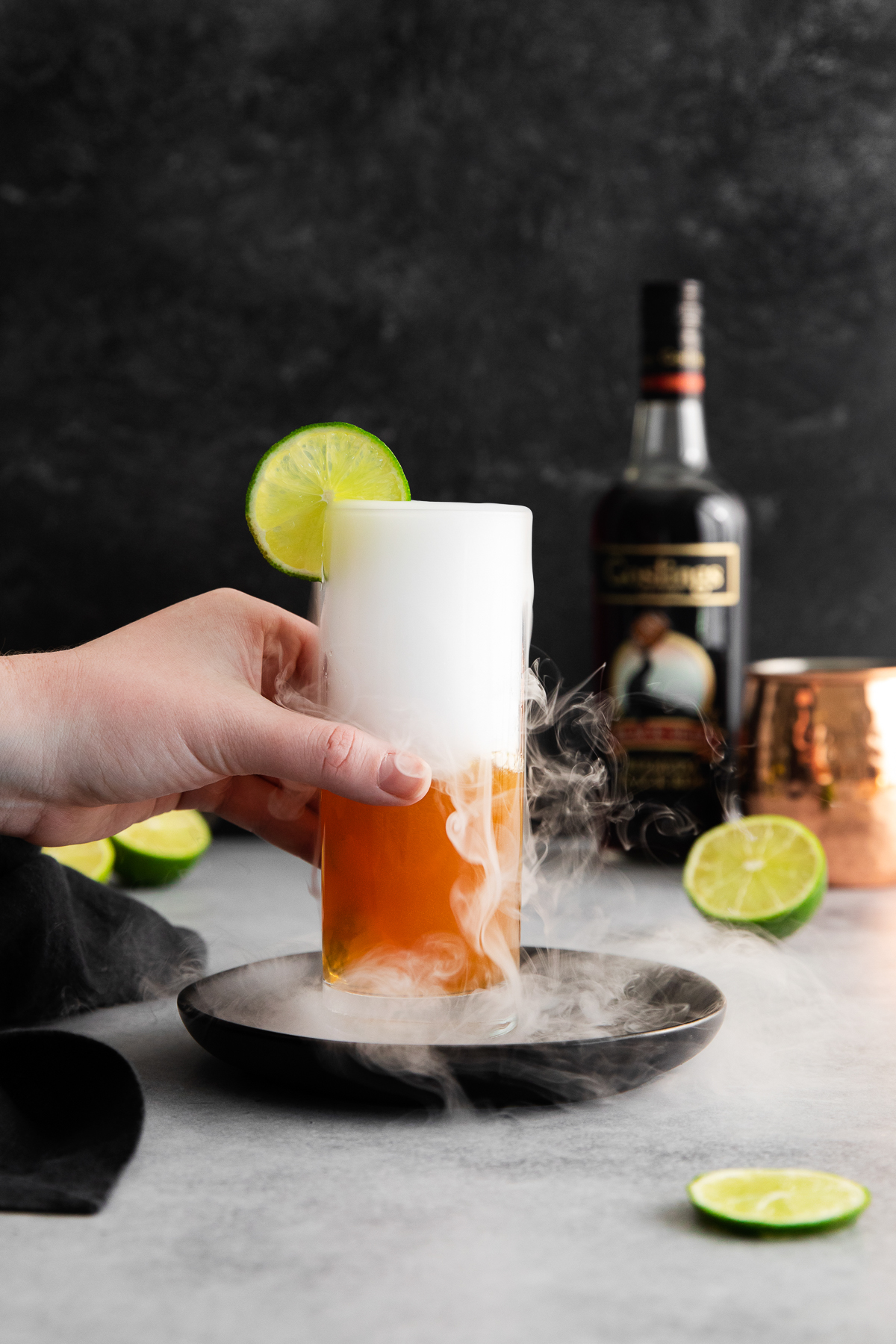 hand holding a smoking Halloween cocktail