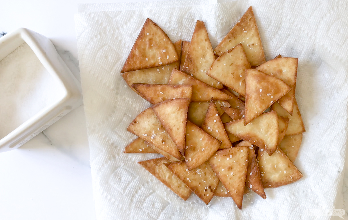 homemade tortilla chips draining on paper towels