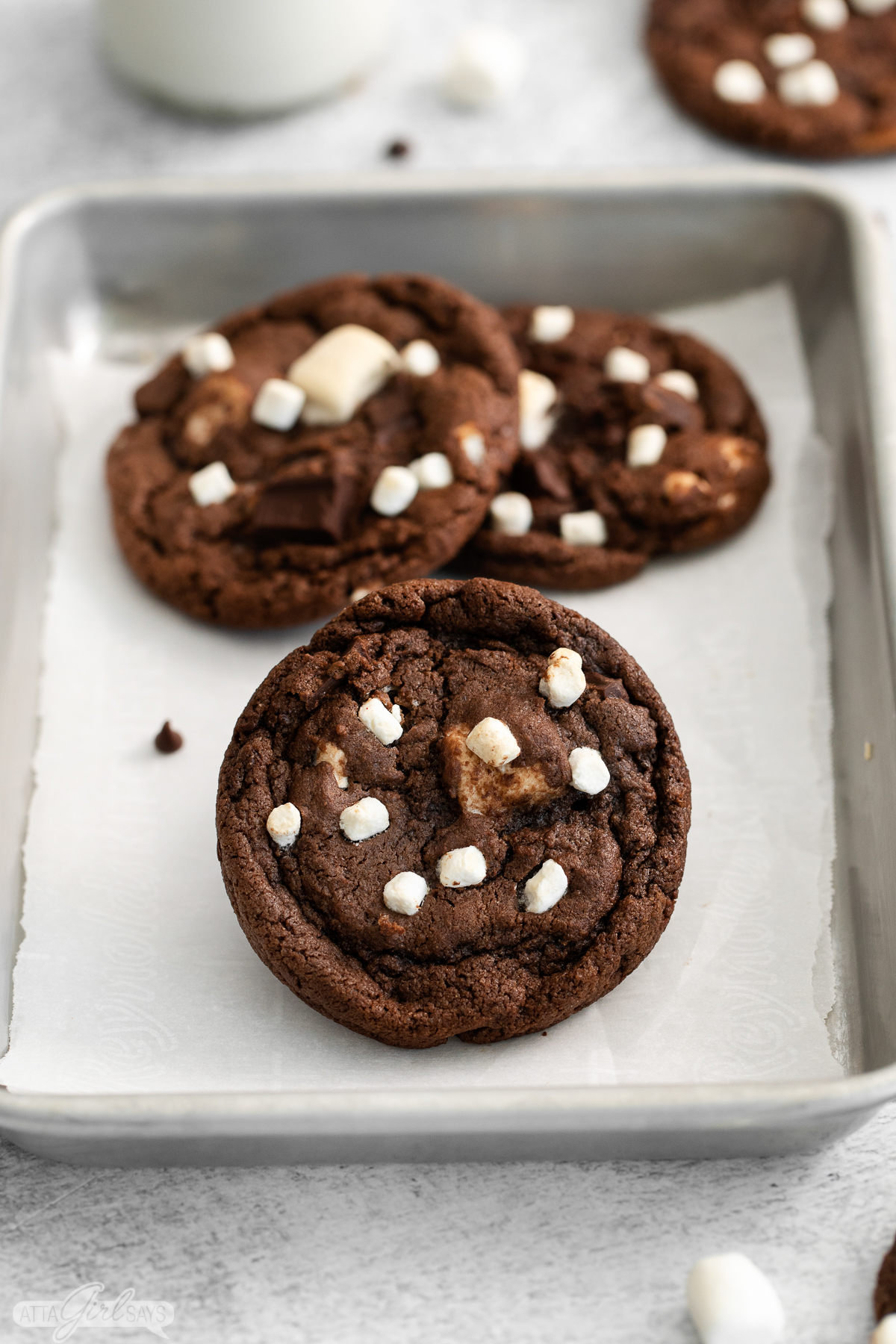 chocolate hot cocoa cookies with marshmallows on a baking pan