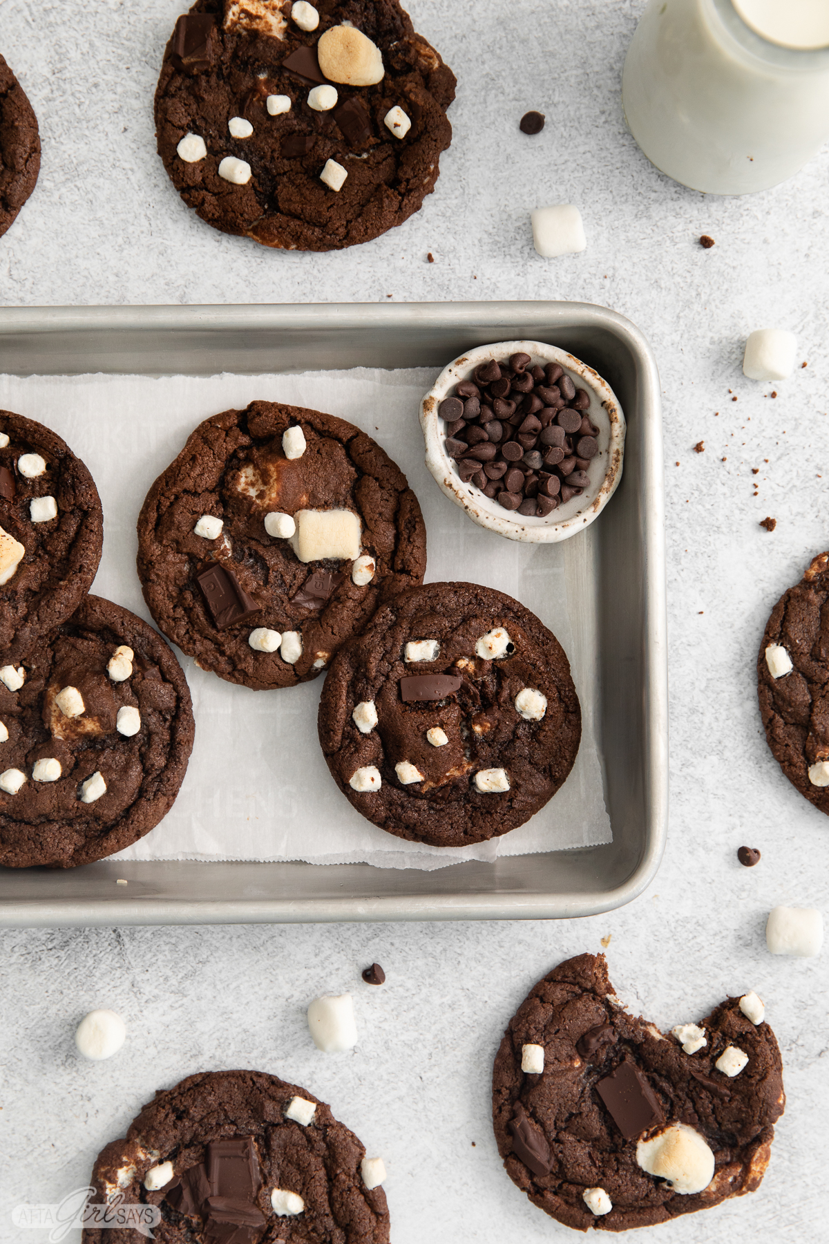 chocolate and marshmallow cookies on a baking sheet with chocolate chunks