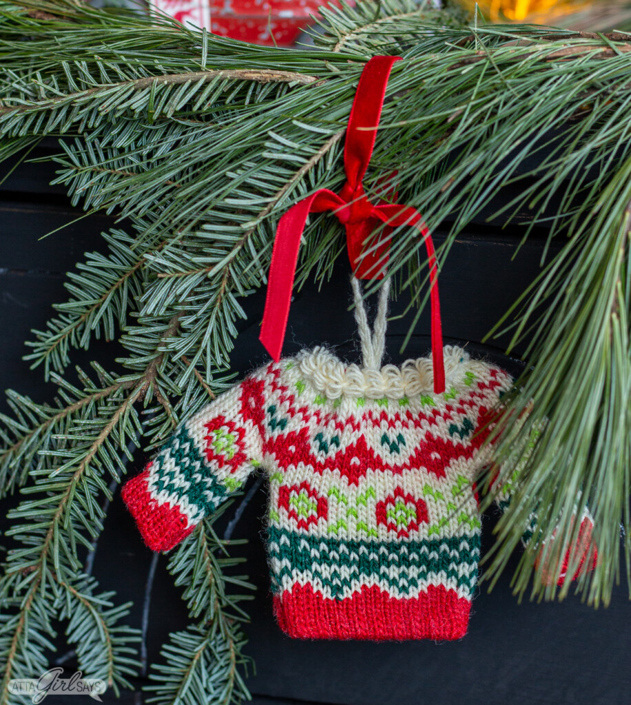 festive mini Christmas sweater ornament hanging from a garland