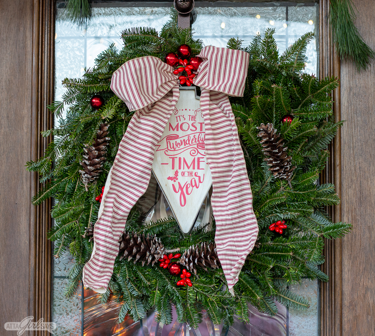 Christmas evergreen wreath with tickling ribbon and pinecones 