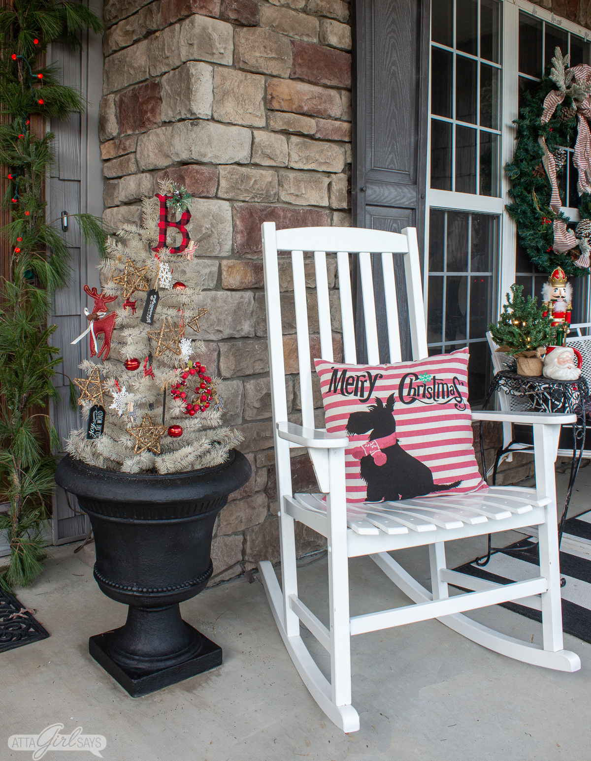 rocking chair next to an planter urn with a white Christmas tree