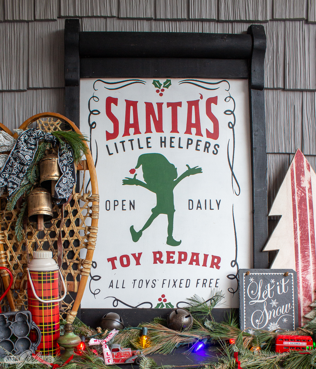 Handpainted elf Santa's Little Helper sign with snowshoes and other Christmas decorations