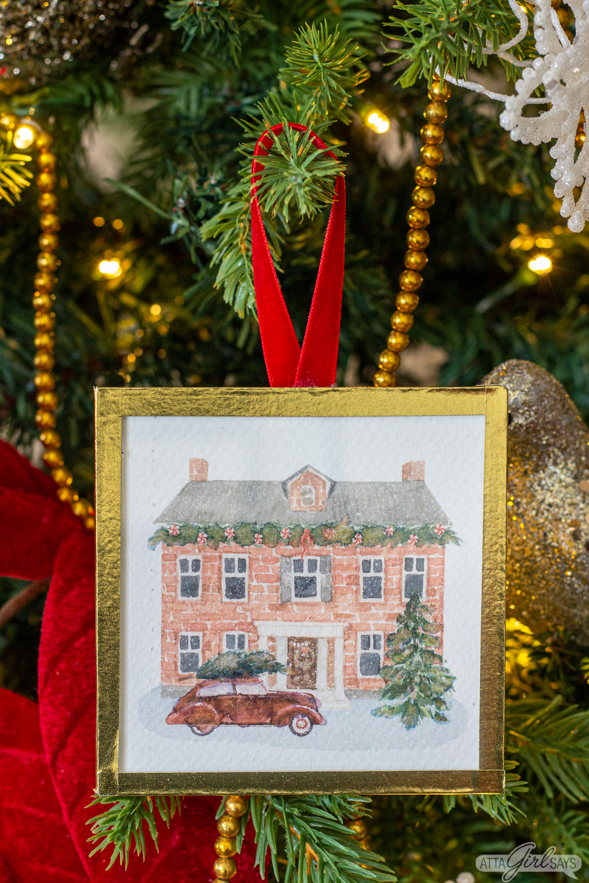 watercolor Christmas ornament of a brick house with a red car in front of it