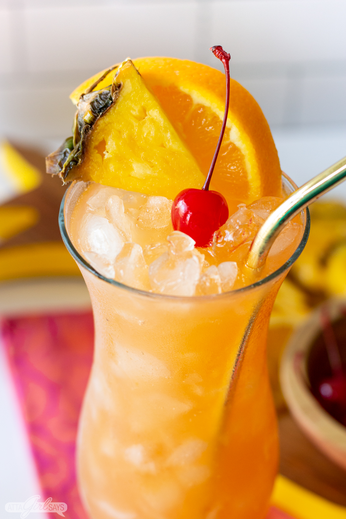 hurricane cocktail in a glass with orange slice and cherry