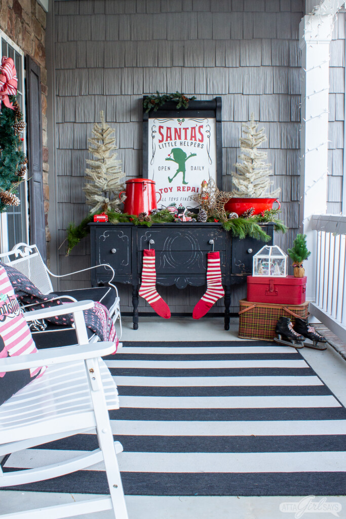 black buffet decorated for Christmas on a front porch