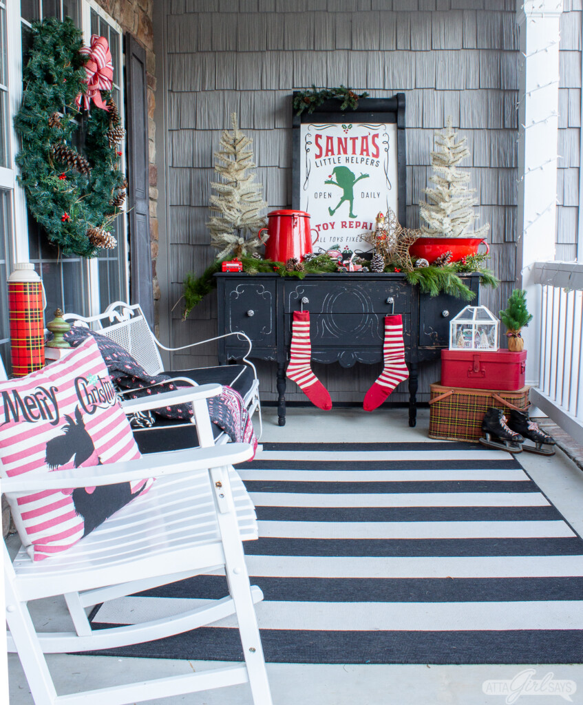black buffet decorated for Christmas on a front porch