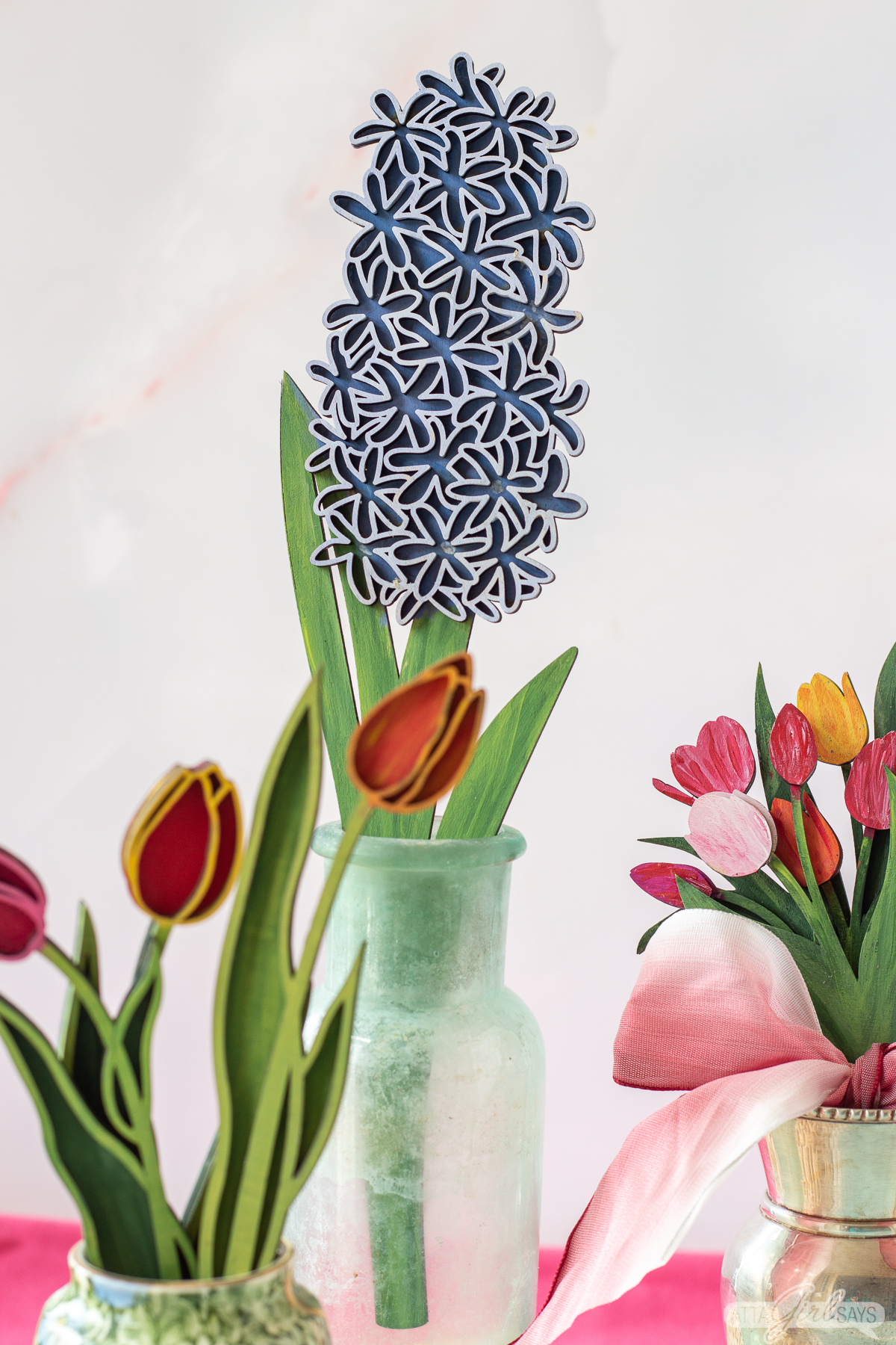 painted wooden flowers in vases