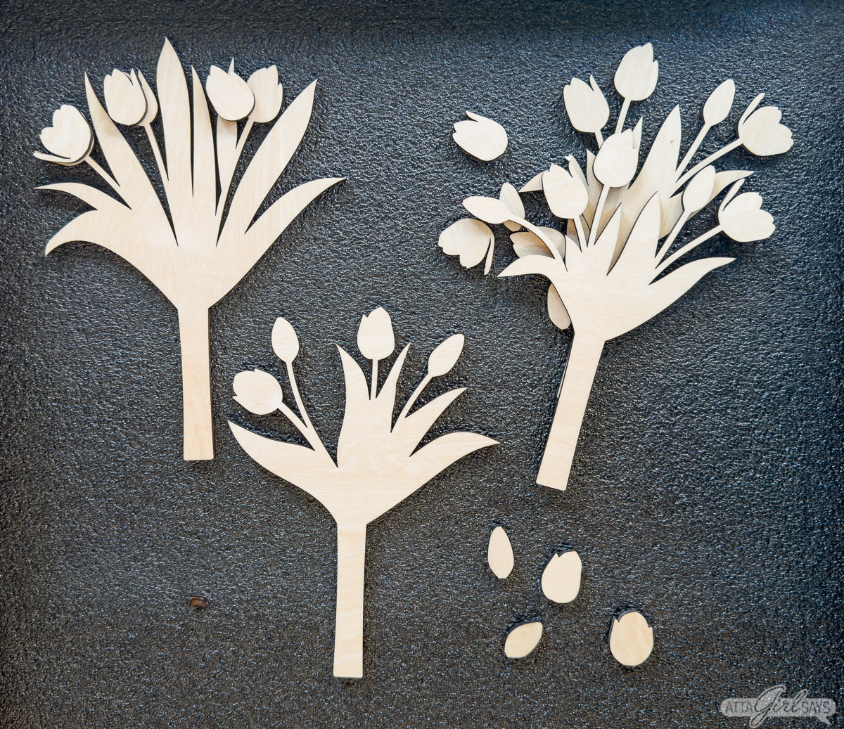 layered laser cut wood flowers on a gray background