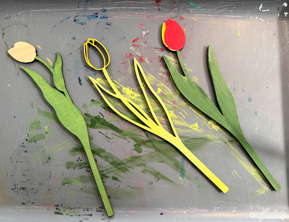 painted wooden laser cut tulips on a gray tray