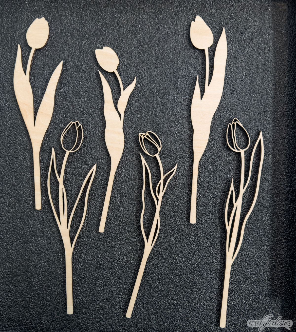 3D wood laser cut tulip flowers on a gray background