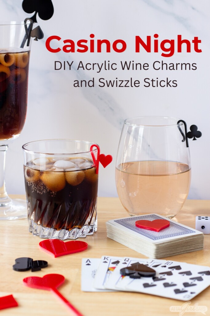 cocktail and wine glasses with acrylic stirrers and glass markers on a table with playing cards