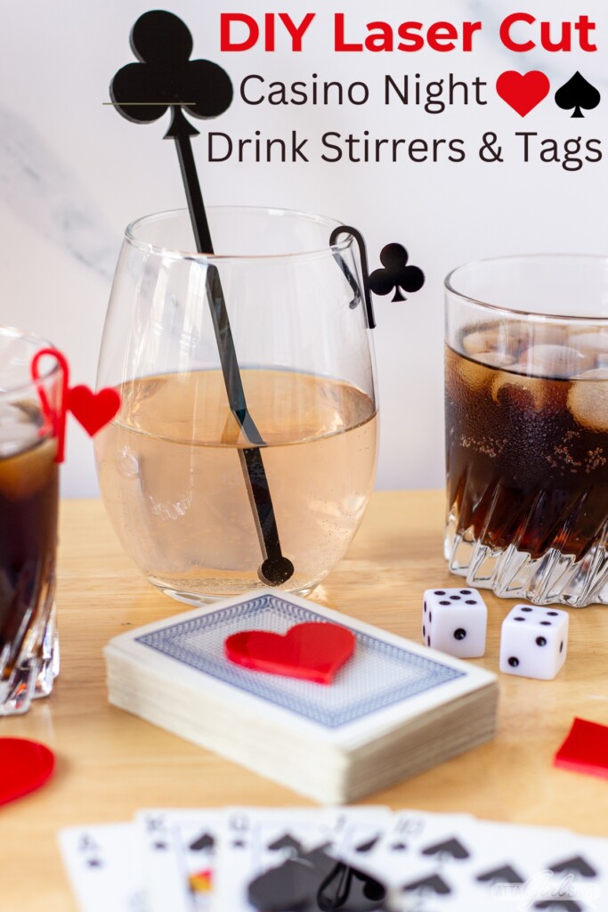 cocktail and wine glasses with acrylic stirrers and glass markers on a table with playing cards