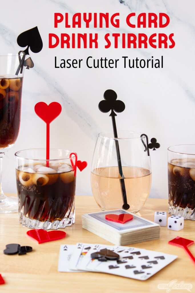 cocktail and wine glasses with acrylic stirrers and glass markers on a table with playing cards