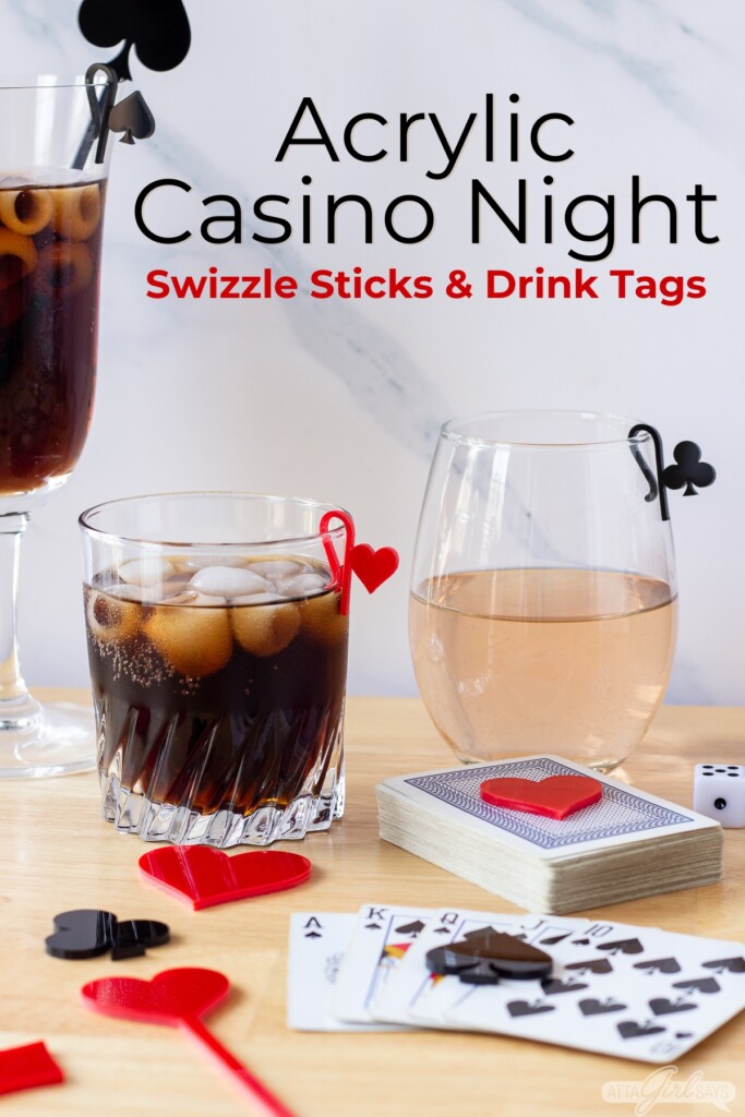 cocktail and wine glasses with acrylic glass marker tags on a table with playing cards