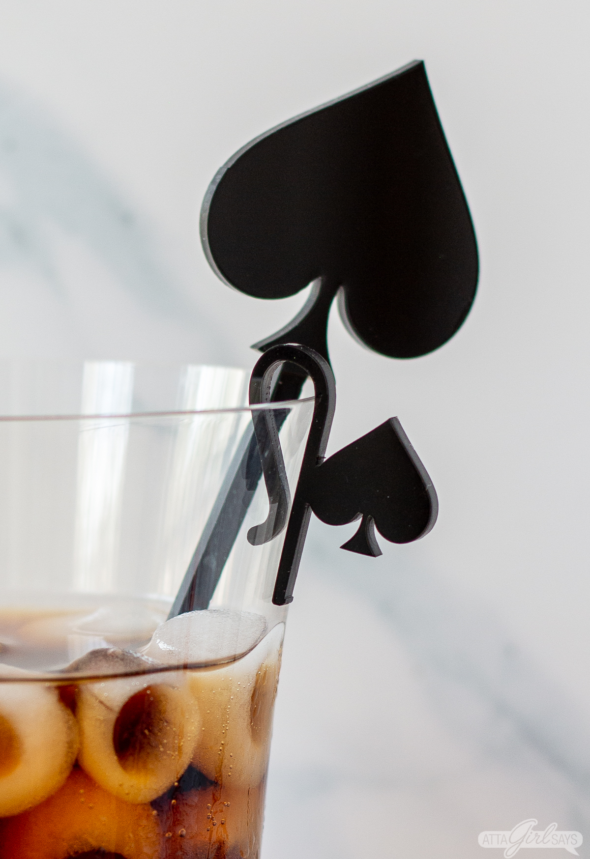 acrylic spade cocktail stir stick and wine glass charm in a wine glass