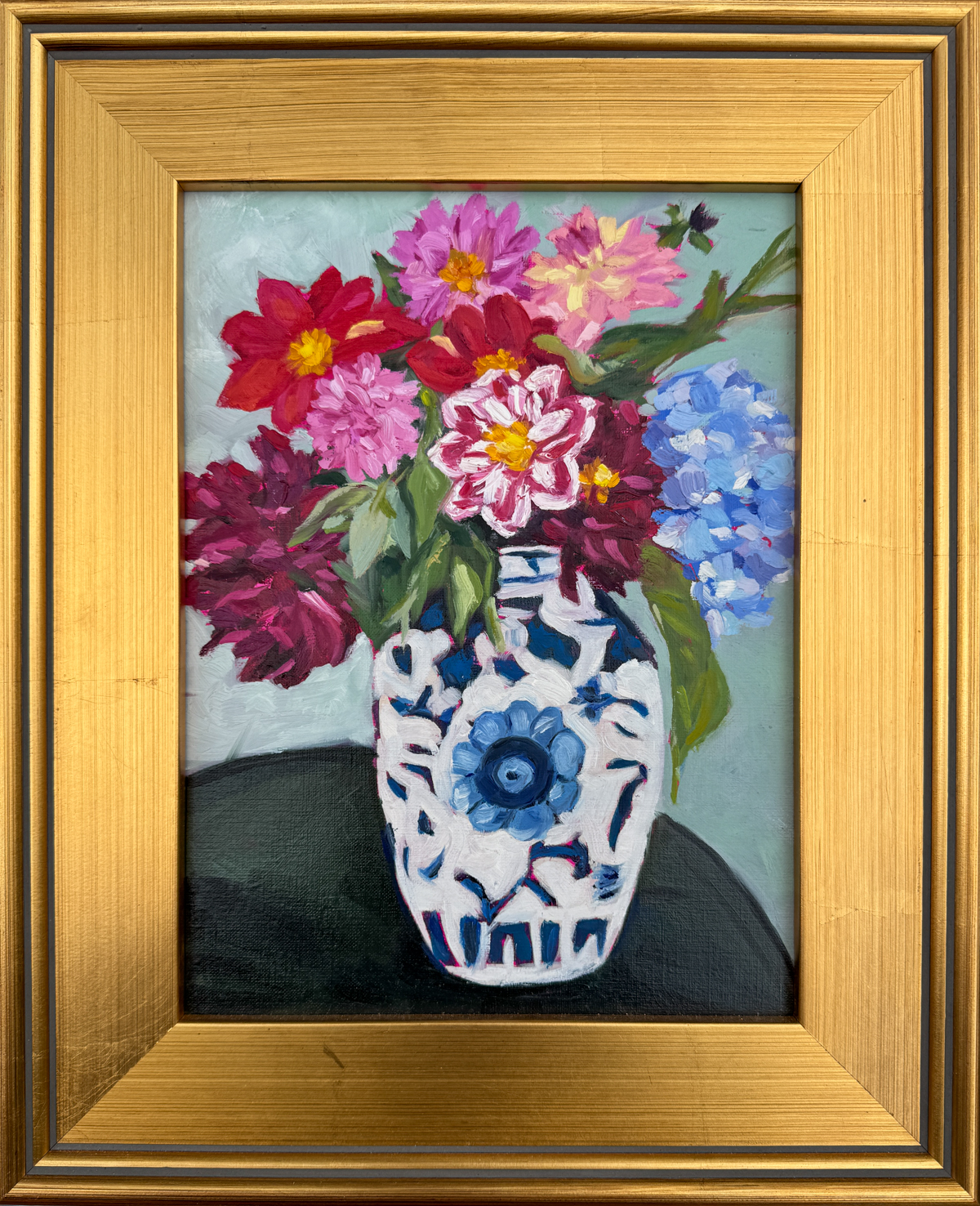 oil painting of dahlias and hydrangea flowers in blue-and-white vase in  a gold frame