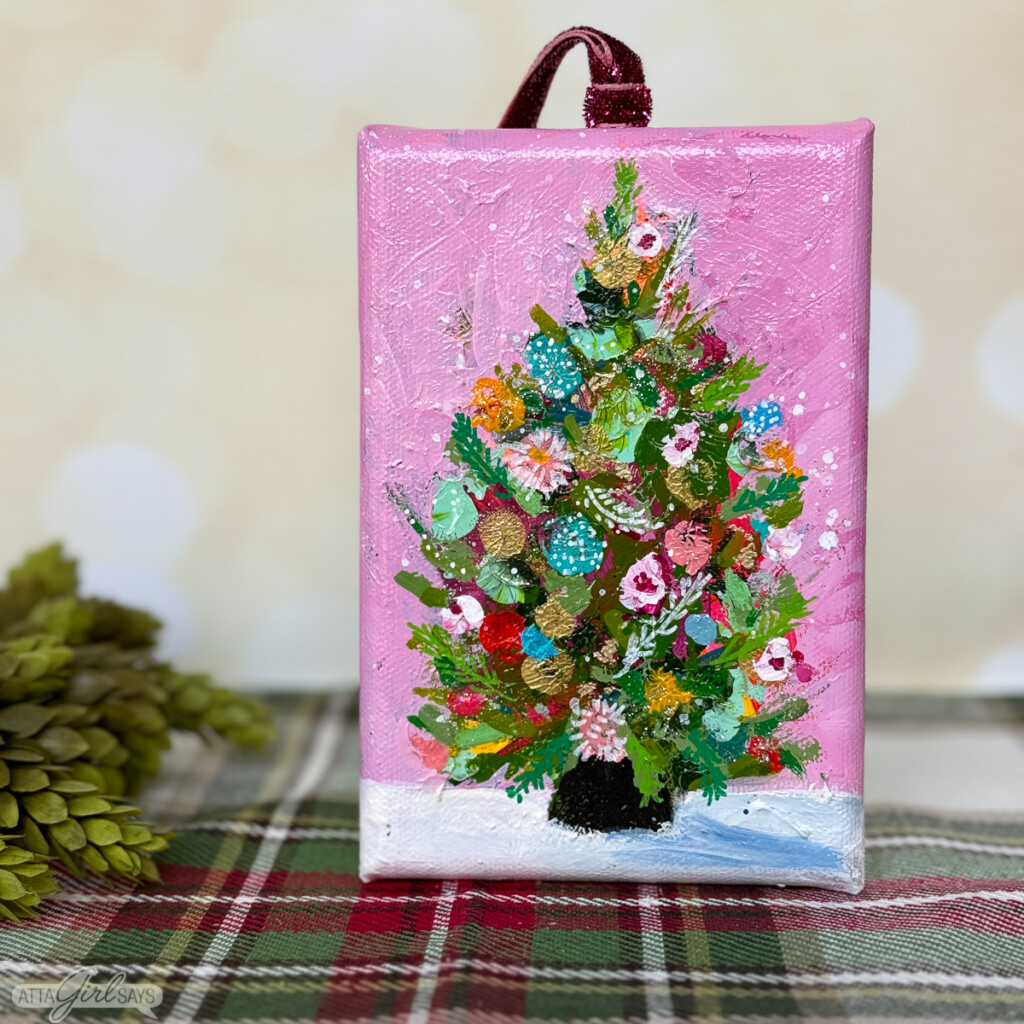 small painting of a Christmas tree with a pink background