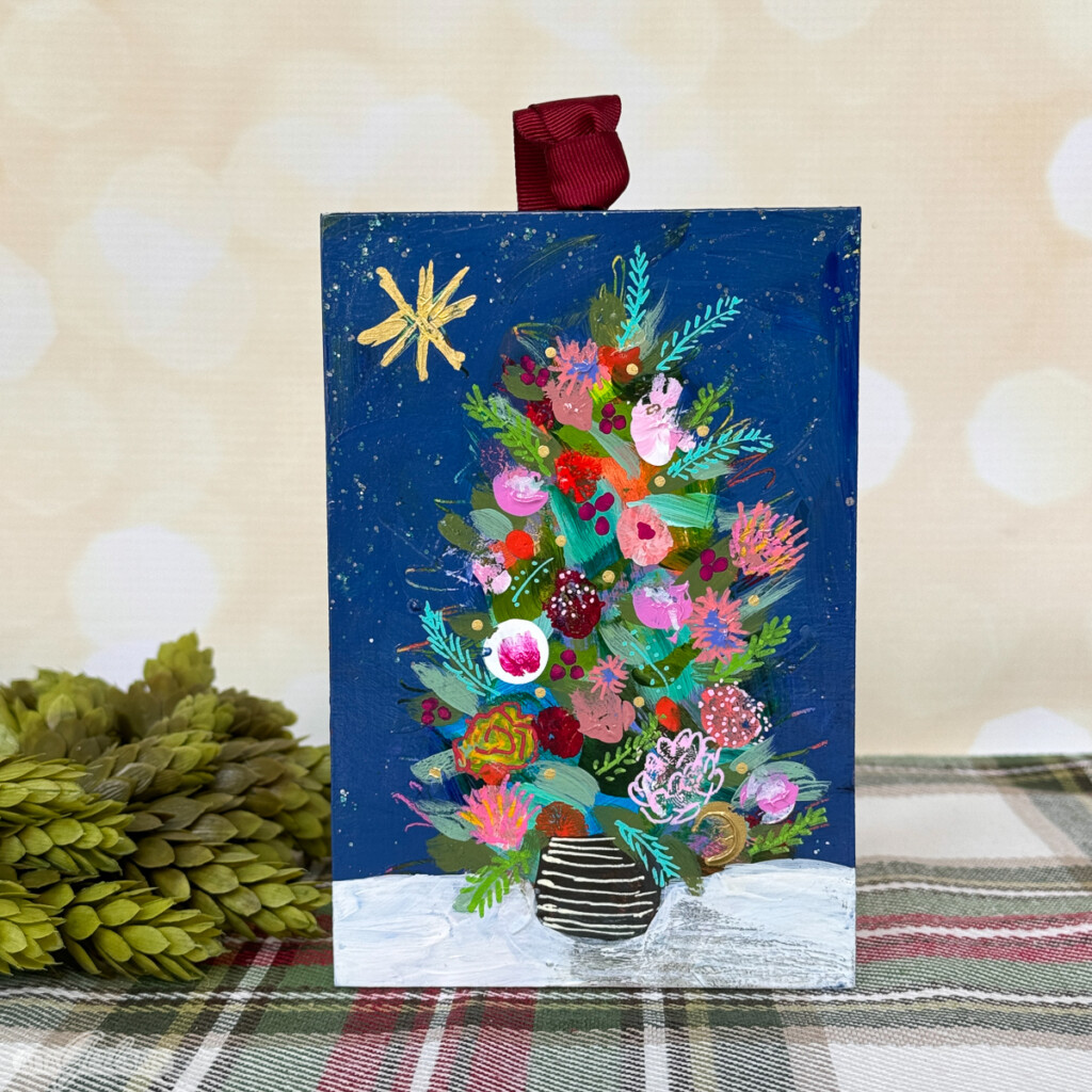 impressionistic painting of a Christmas tree on a snowy night