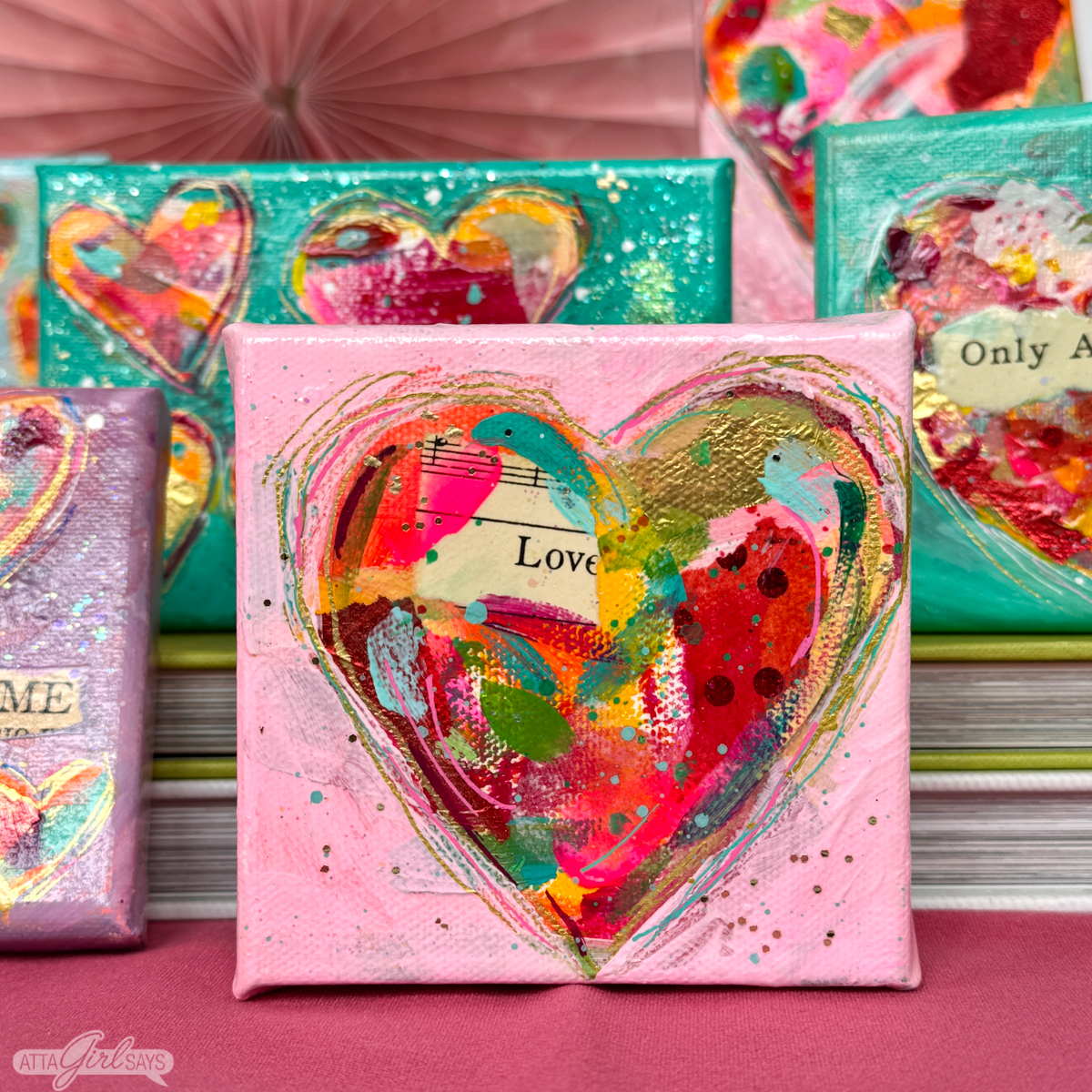 heart collage paintings on small pink and aqua canvases